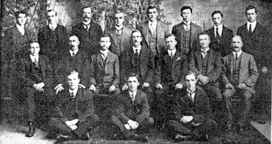 The ATO's first officials, circa 1915. Left to right, back row: L Roche, S McKellar White, A Bergin, A Hampton, H James, RW Chenoweth, G Garcia, HF Whitlam. Centre row: DM Ray, FW Rose, R Ewing, GA McKay, JS Eastwood, MT Keely, H Brodribb. Front row: H Storey, L Adams, T Ryan. Notable are GA McKay, first Commissioner of Taxation; R Ewing, second Commissioner of Taxation; S McKellar White, later Deputy Commissioner for Queensland; RW Chenoweth, later Deputy Commissioner for Victoria; and HF Whitlam who became Solicitor General and whose son Gough became Prime Minister in the 1970s.
